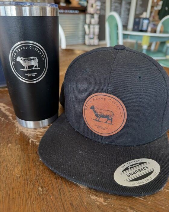 Black Sheep Coffee Co. branded tumbler and hat