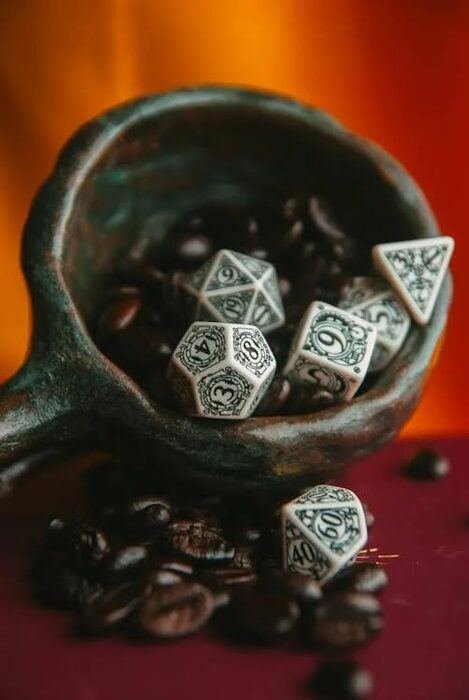 Dice in a cup of coffee beans
