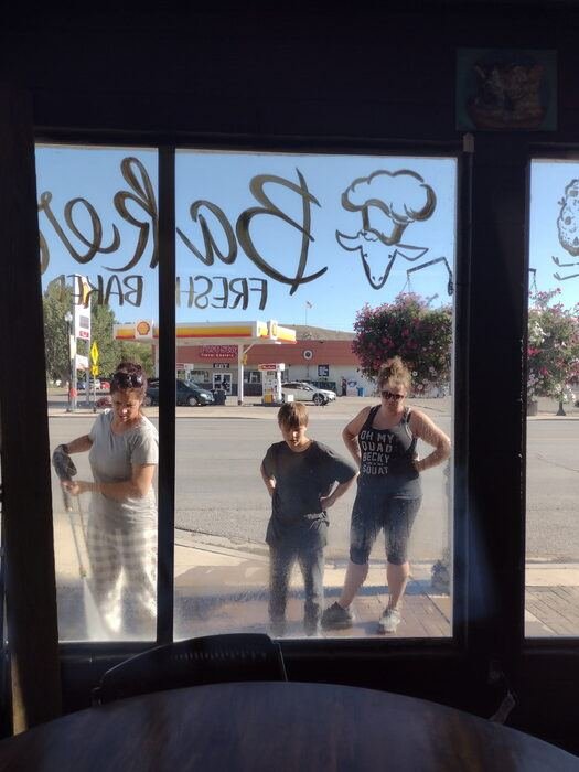 Cleaning the front windows at Black Sheep Coffee