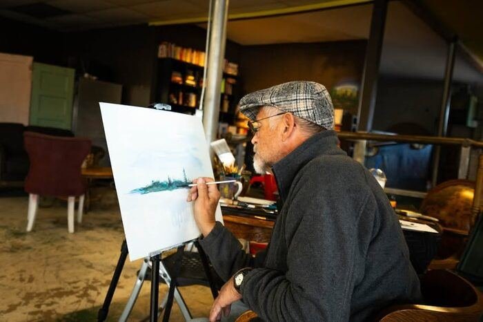 A community member painting during paint night at Black Sheep Coffee